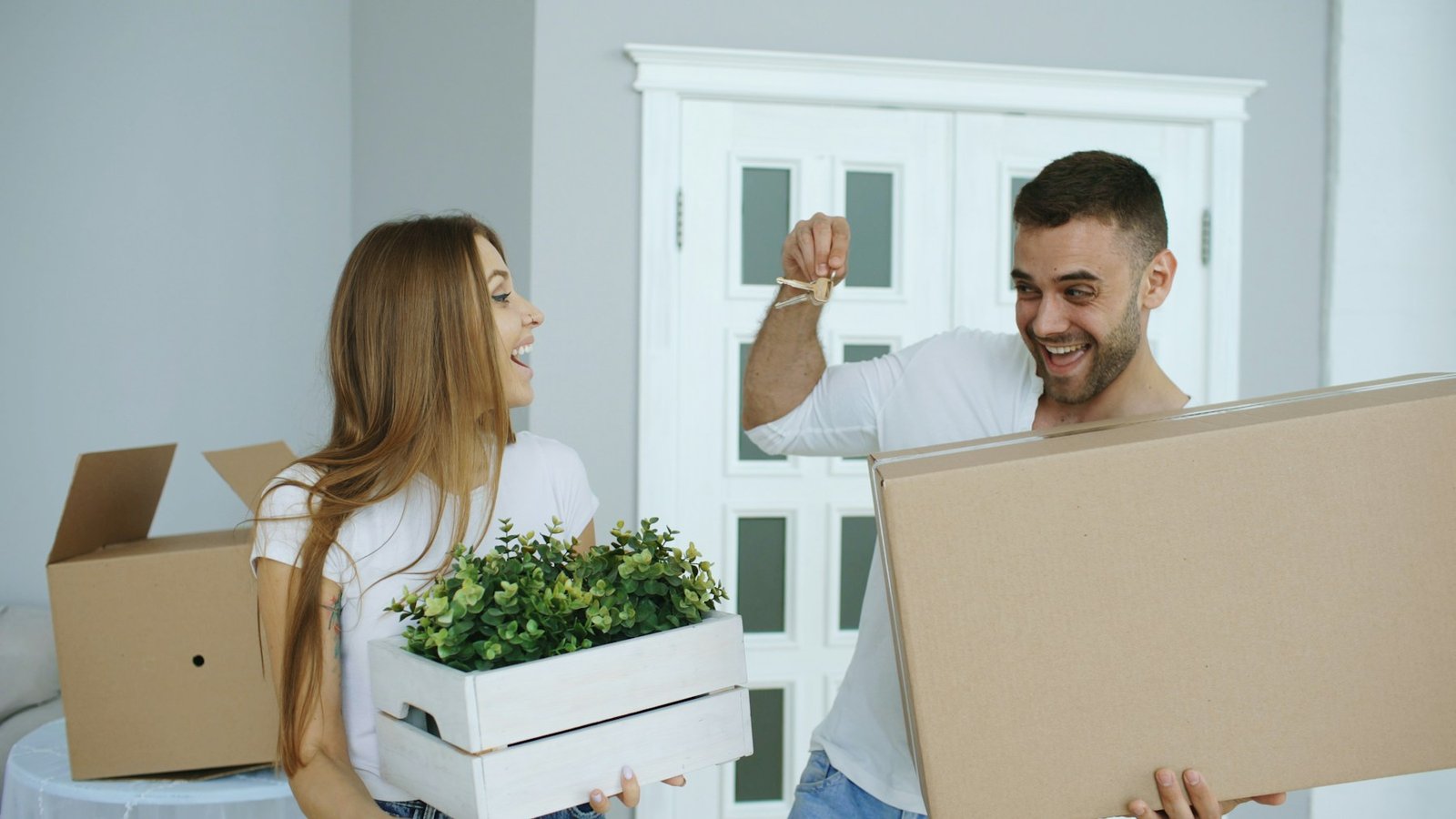 Happy new homeowners holding the keys to their home